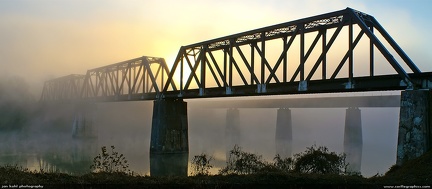 Bridges in the Fog -- Spectacular photo of Mount Holly railway bridges with the sunrise blazing through the fog.