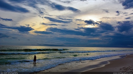 Evening Walk -- Woman walks in the surf at Panama City, Fla