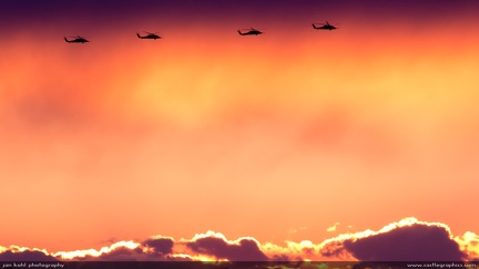 Sunset Blackhawks -- Four Blackhawks ride the clouds at dusk.