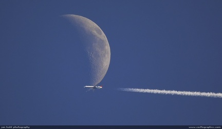 Landing on the Moon -- An airliner caught just as it crosses the moon's face