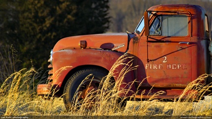 Forgotten Firetruck -- An old firetruck rests in an open field on a late winter afternoon