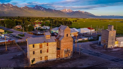 Ronan Elevators -- The old deserted grain elevators at the edge of town in Ronan, Montana make a great foreground for the backdrop of the sunset-illuminated Mission Mountains.  
The tallest peak, the 9,800 ft McDonald Peak, is at center.